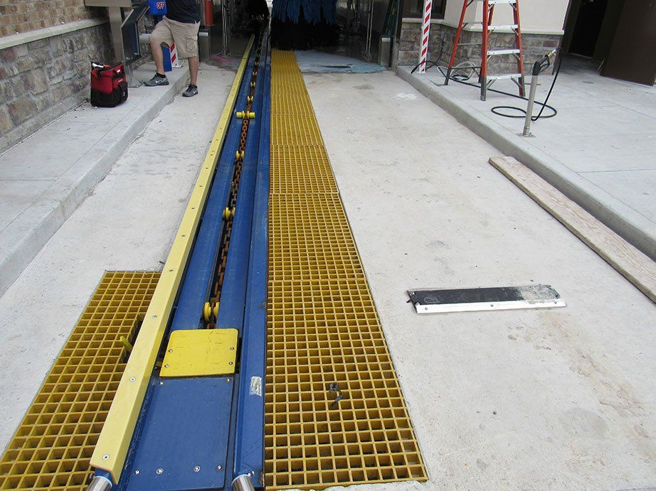 A blue and yellow drain with a ladder in the background
