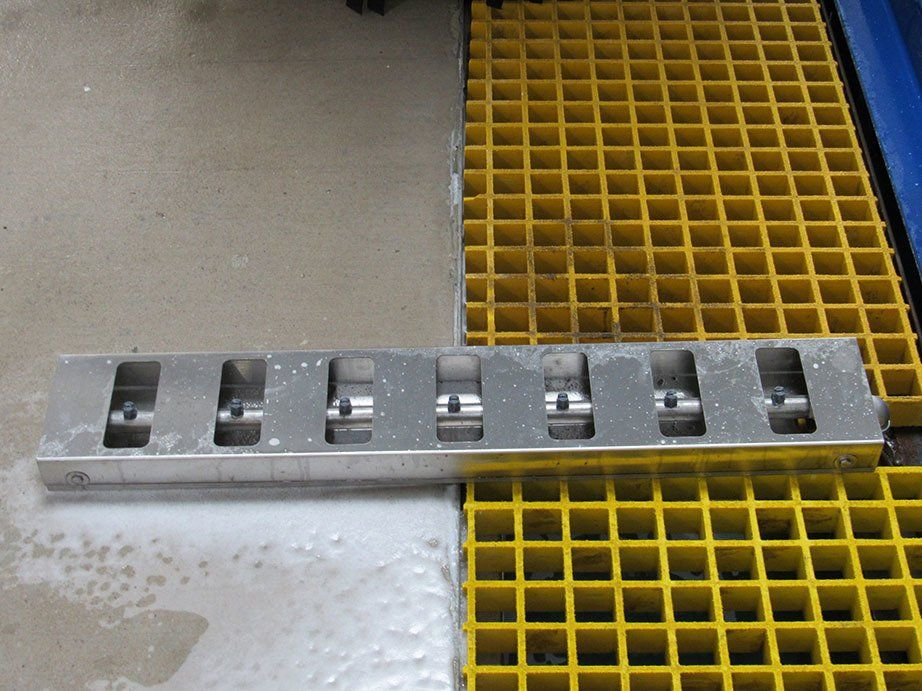 A metal grate is sitting on top of a yellow grate