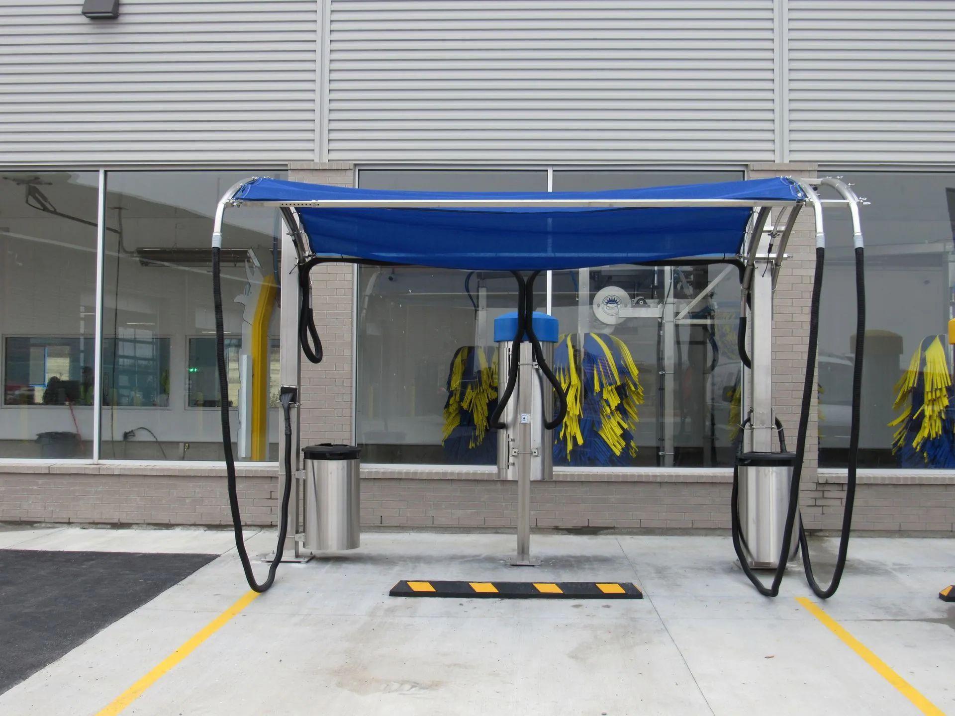 A car wash with a blue canopy over it