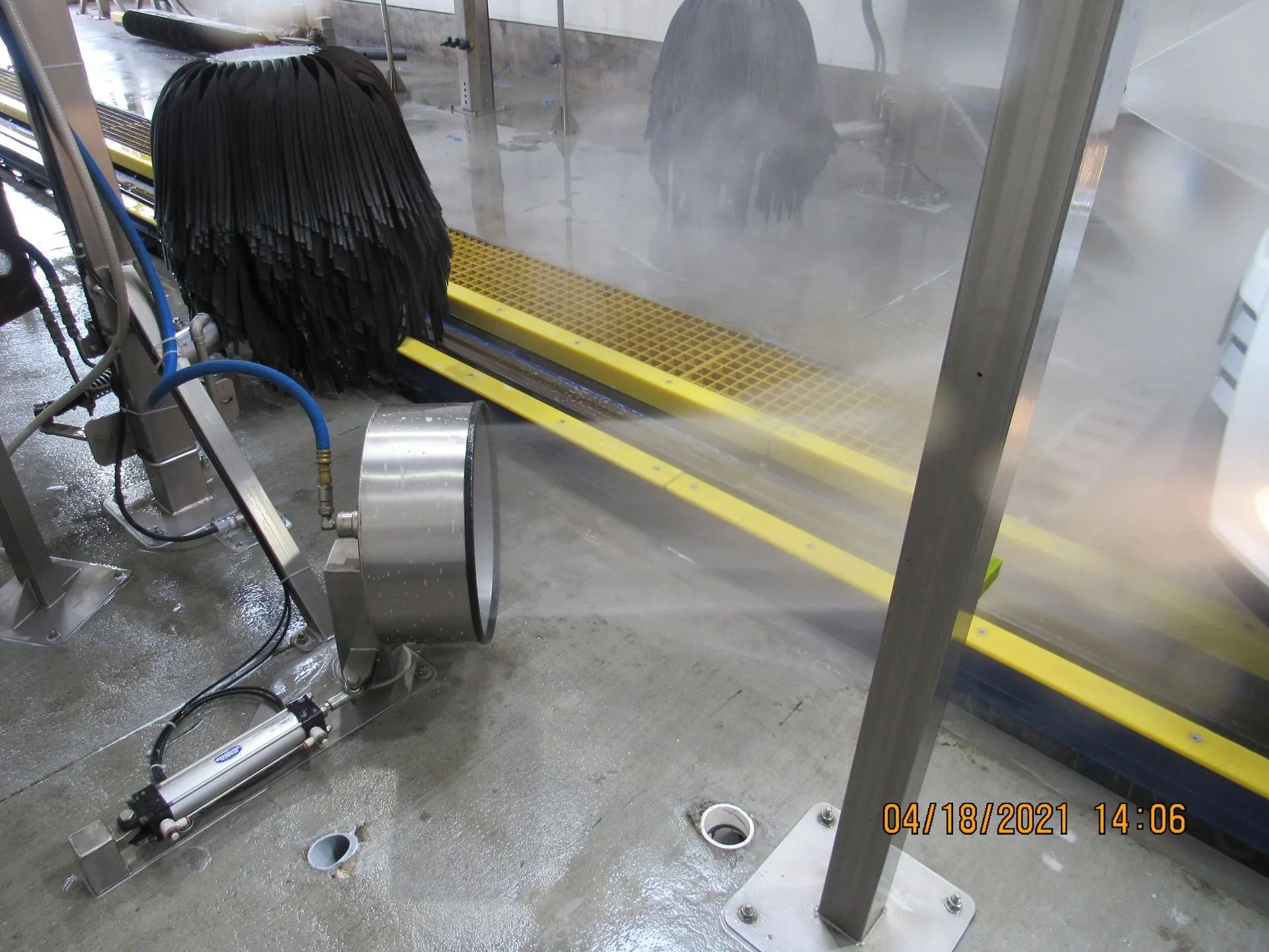 A tire is being cleaned by a machine in a car wash