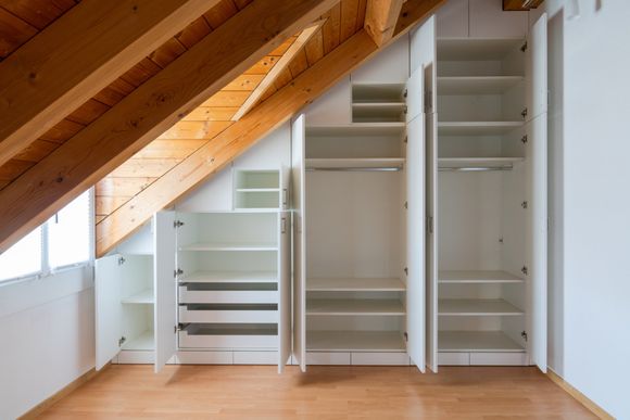 Open Cabinet On Attic — Twin Cities, MN — Top Shelf Painting & Services Open Cabinet On Attic — Twin Cities, MN — Top Shelf Painting & Services