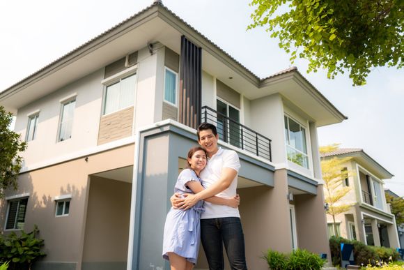 Happy Couple With New Paint House — Twin Cities, MN — Top Shelf Painting & Services Happy Couple With New Paint House — Twin Cities, MN — Top Shelf Painting & Services