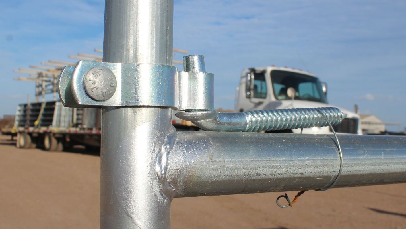 A close up of a metal pipe with a truck in the background.