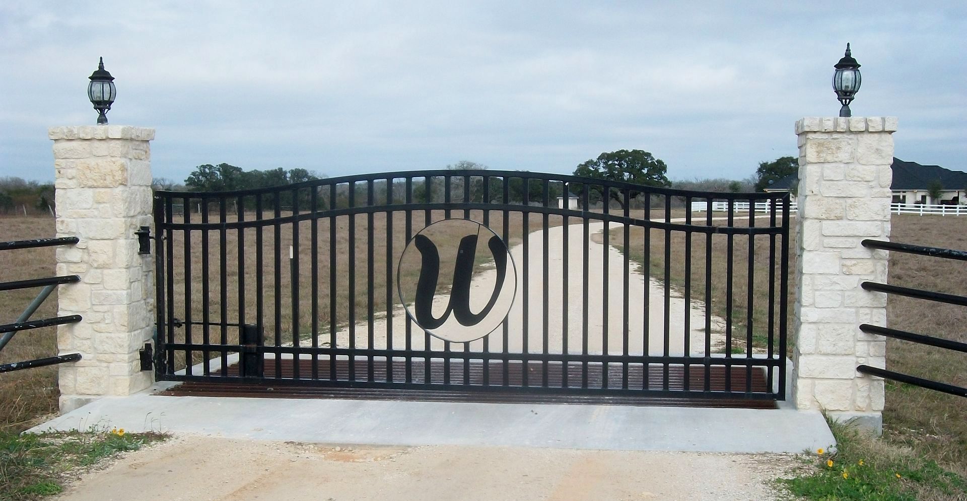 A black gate with the letter w on it