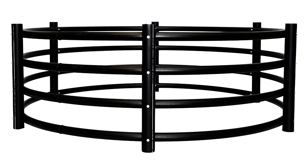 A black metal fence is sitting on top of a lush green field.