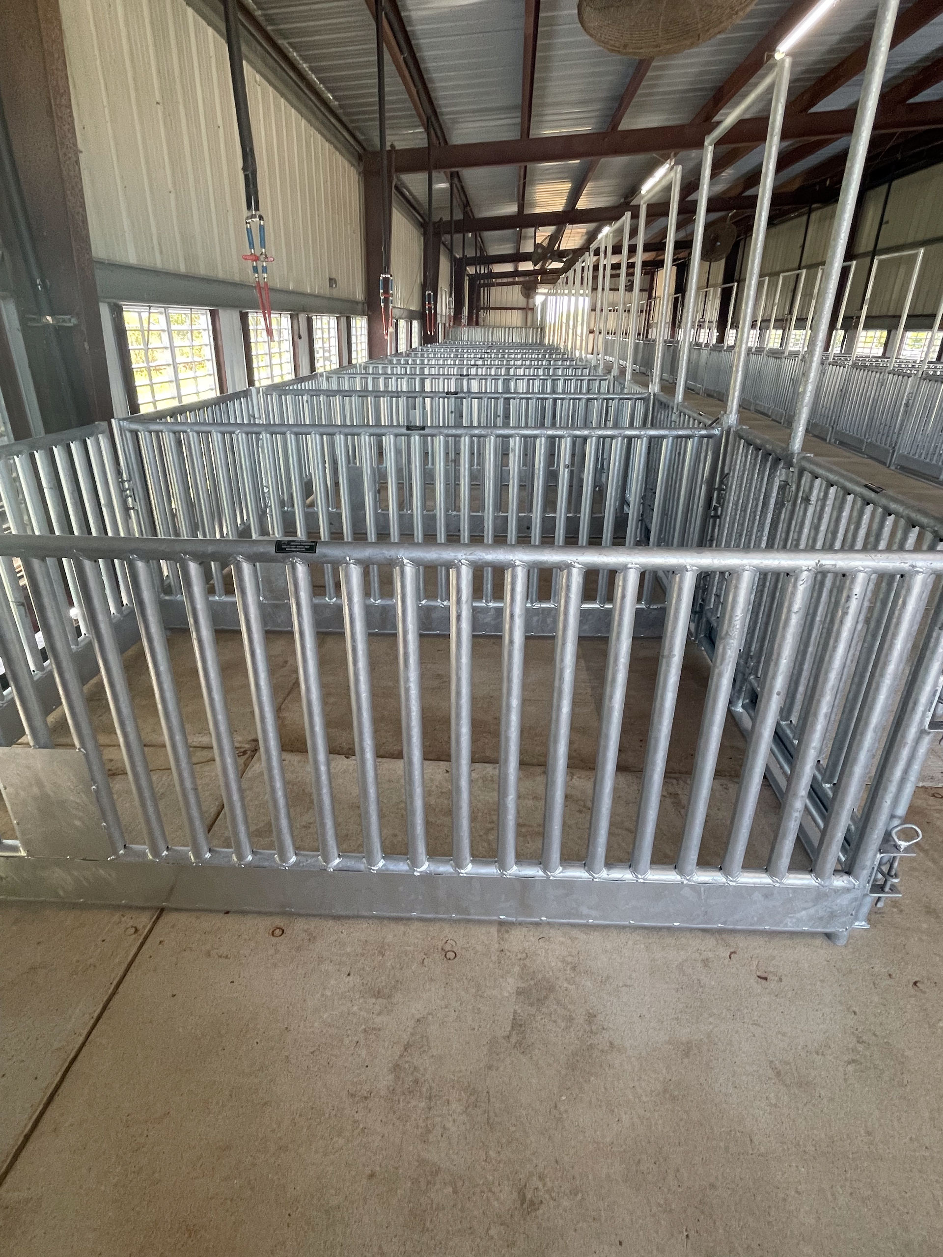 A row of metal fences in a barn.