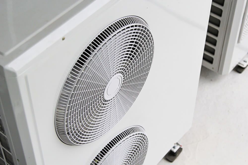 Two Air Conditioners Are Sitting Next to Each Other on The Floor — Care Mechanical Services in Wagga Wagga, NSW