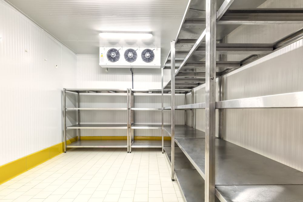 A Person Is Opening a Refrigerator Door with Their Hand — Care Mechanical Services in Wagga Wagga, NSW