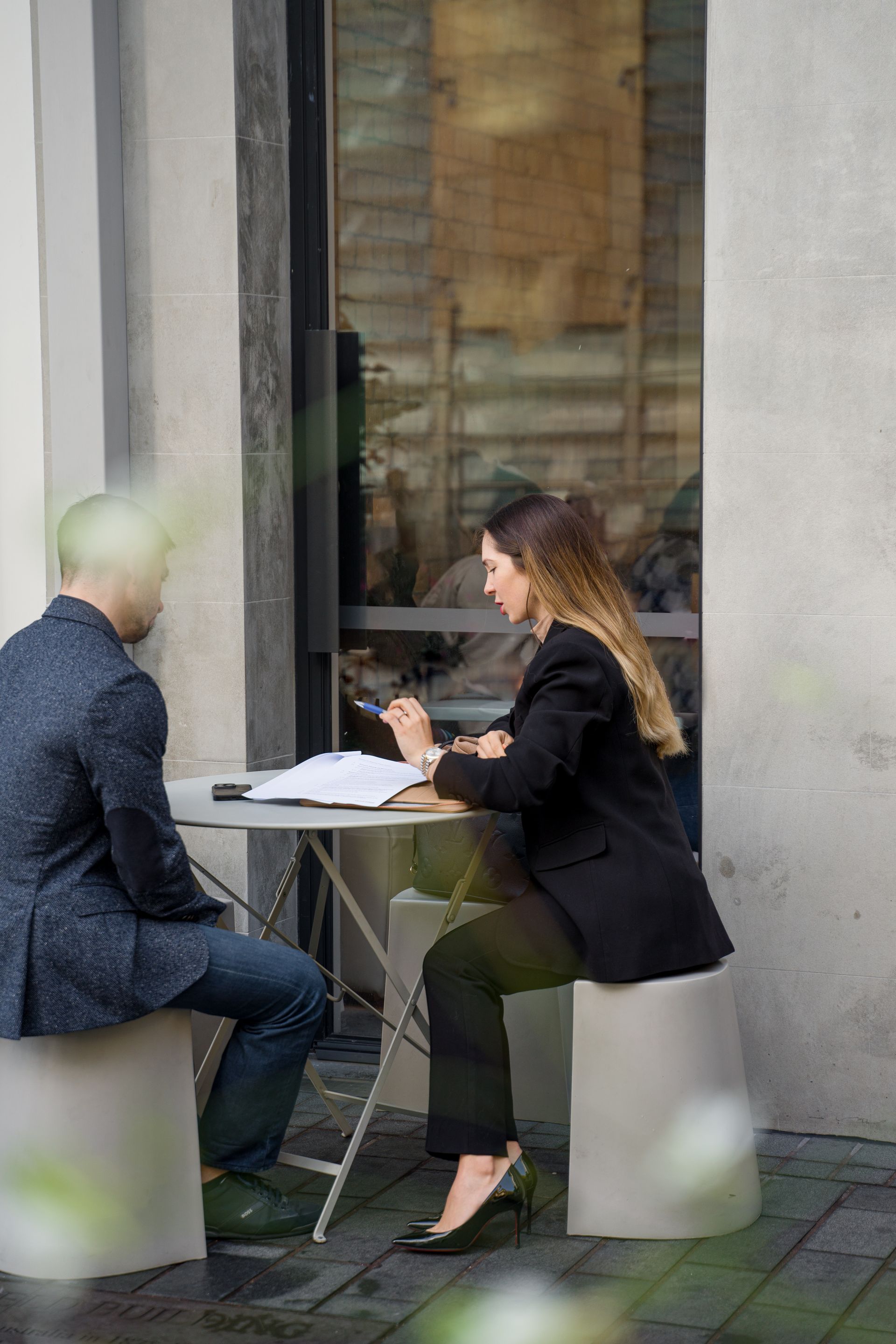 Polina Kozlova meeting a client at an outdoor table