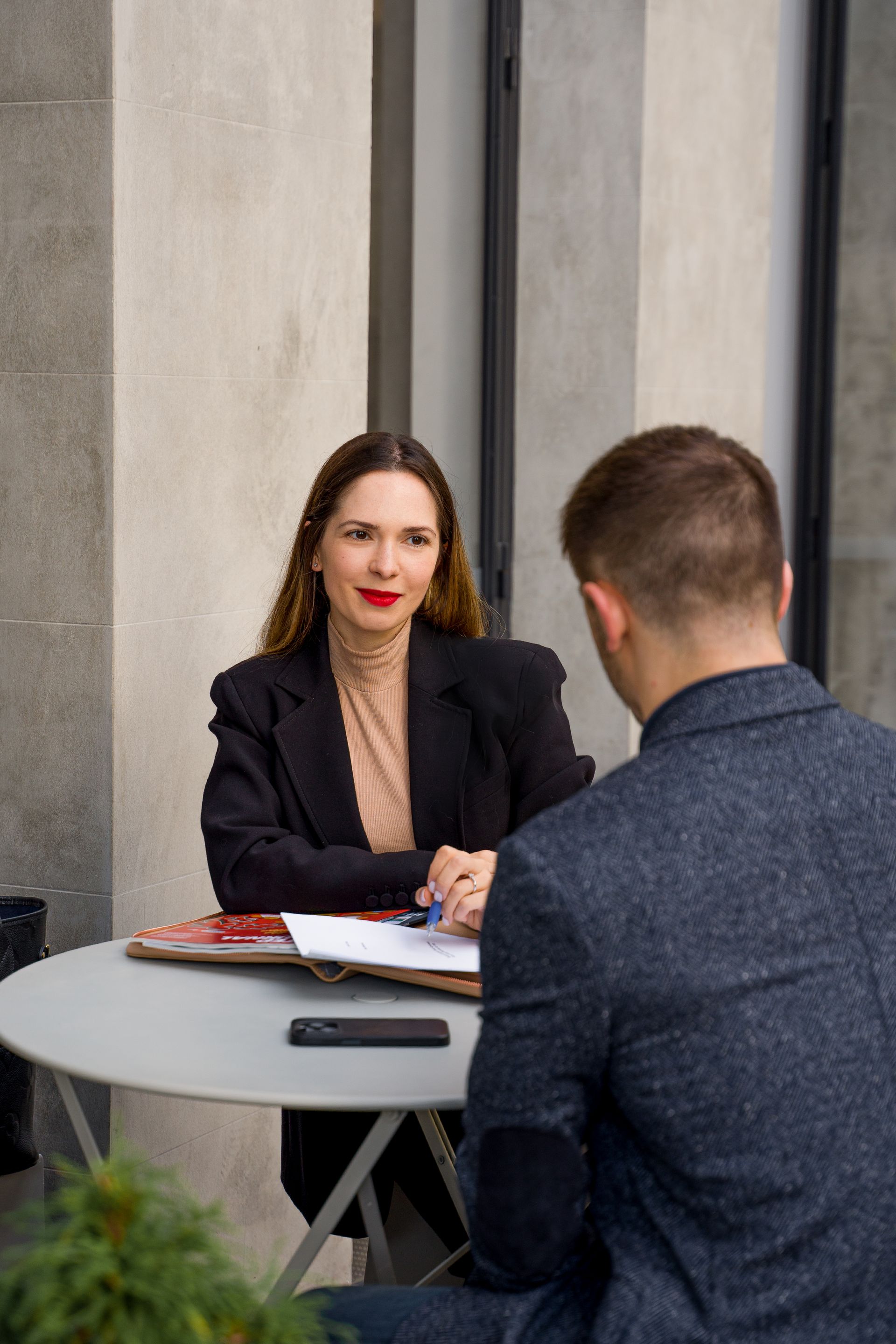Polina Kozlova advising a client at a meeting table