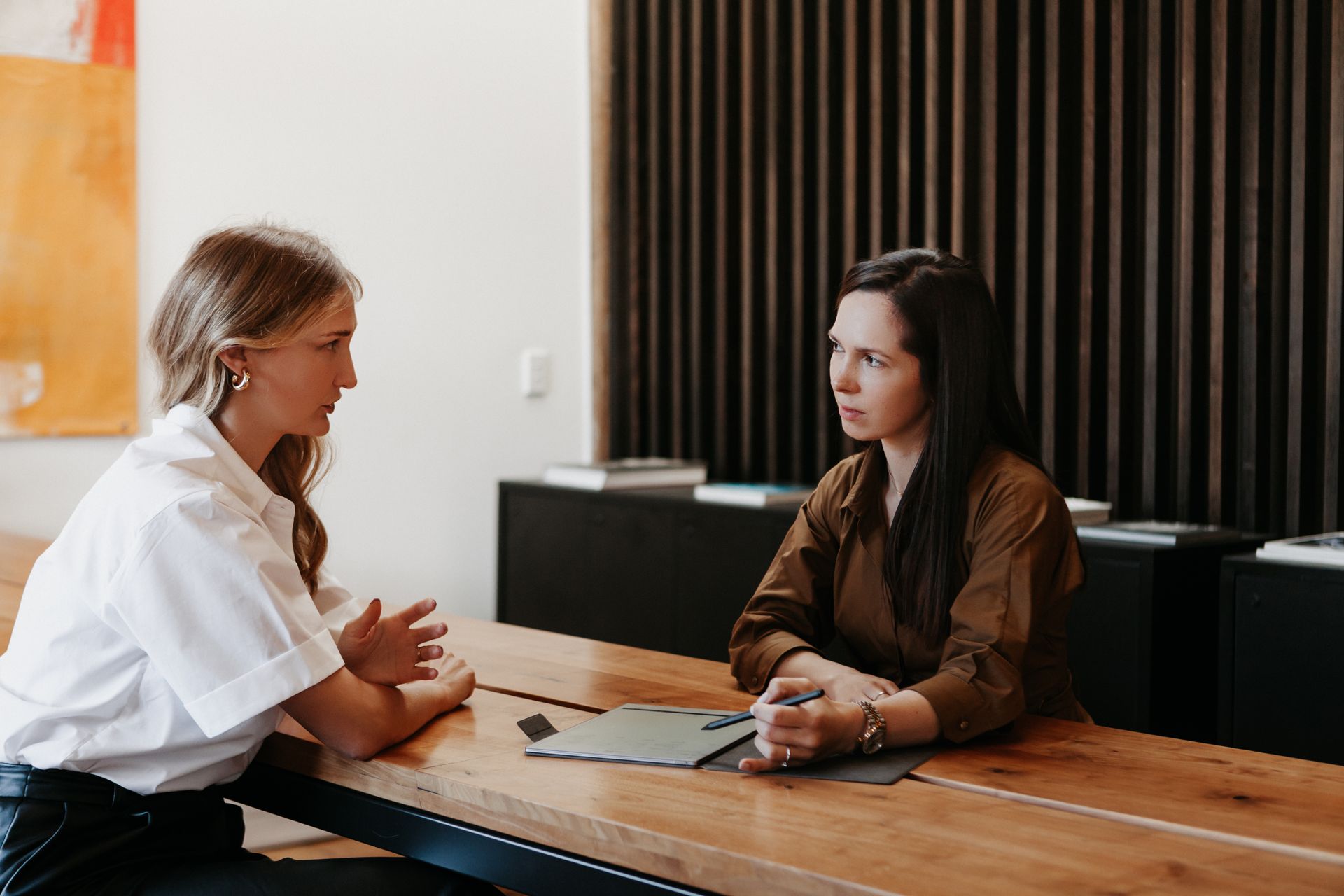 Polina Kozlova talking with a client across a meeting table