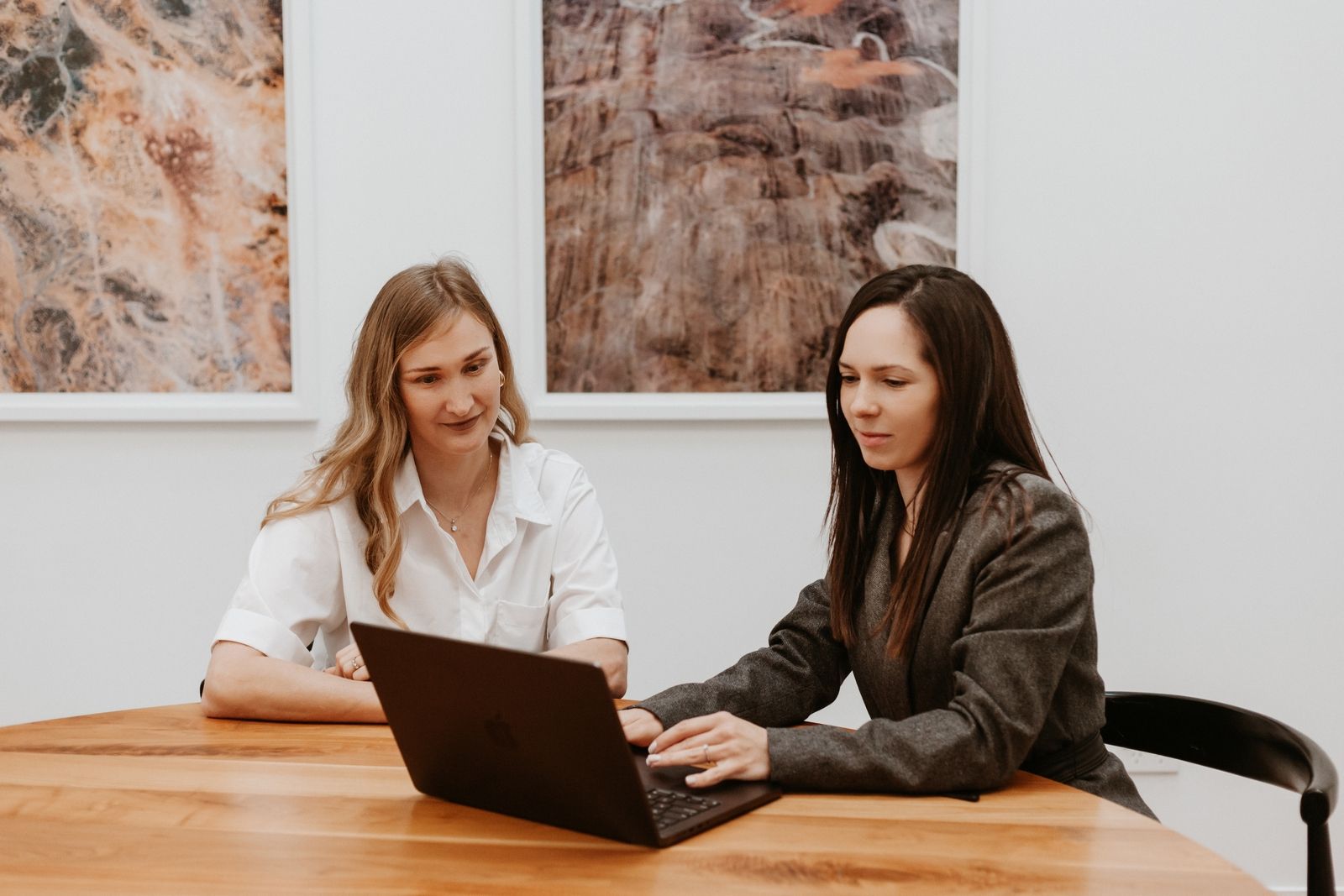 Polina Kozlova and a client reviewing documents on a laptop