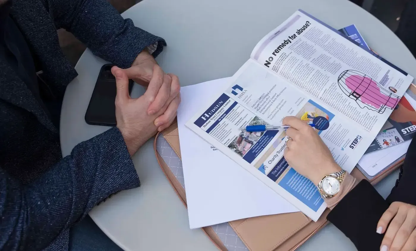 Lawyer and client reviewing printed documents at a table