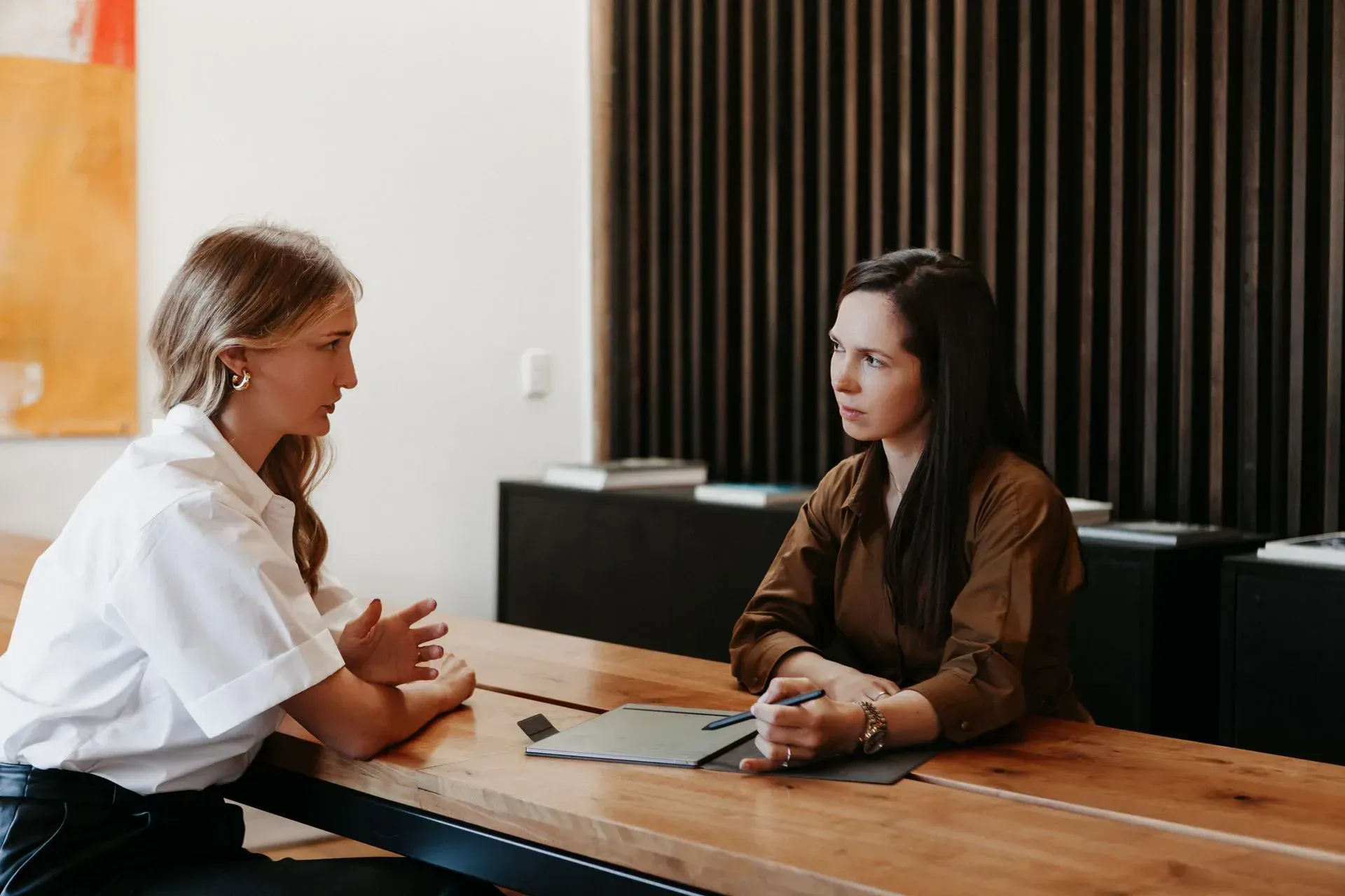 Polina Kozlova listening to a client during a consultation