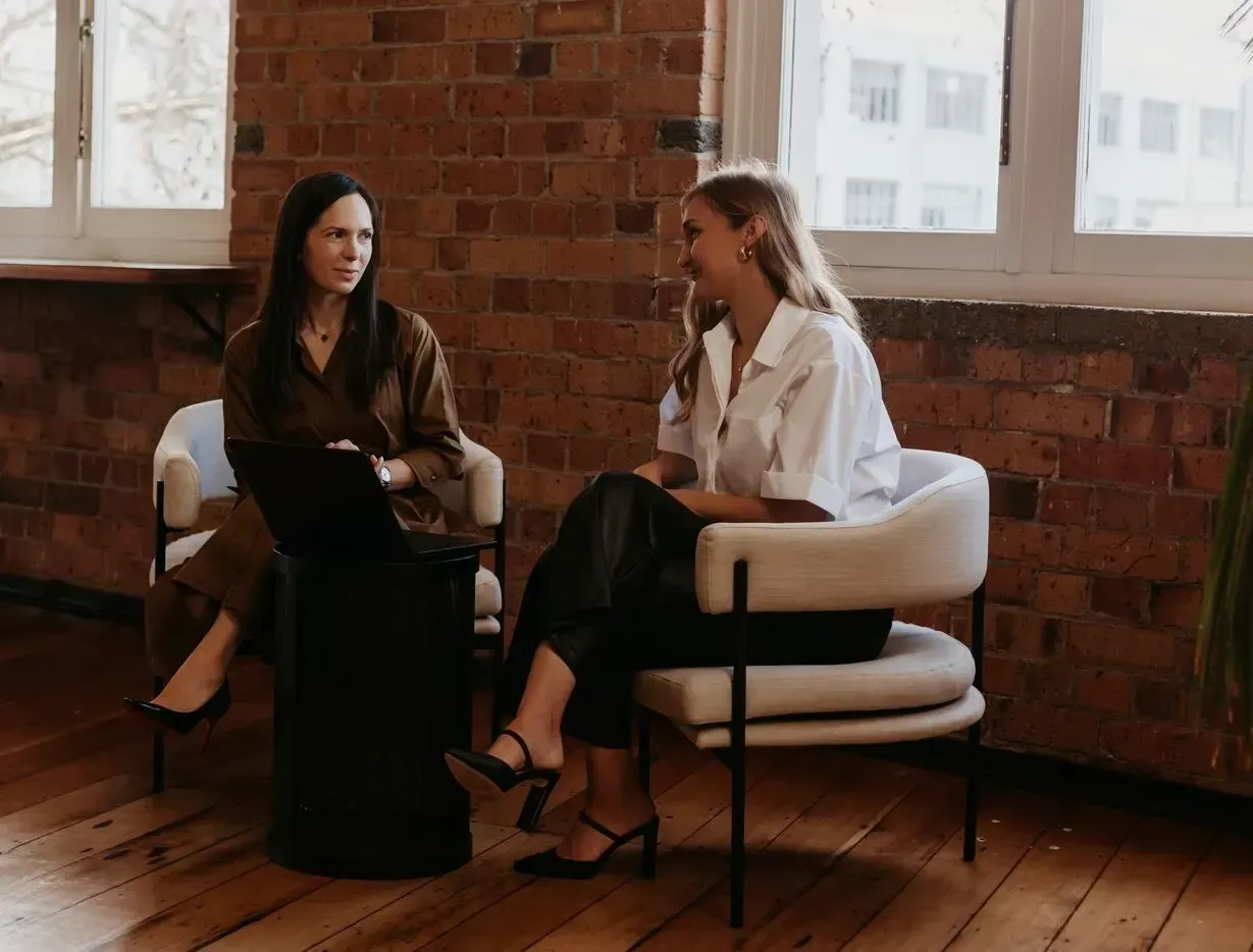 Polina Kozlova talking with a colleague in the PK Law office, central Auckland