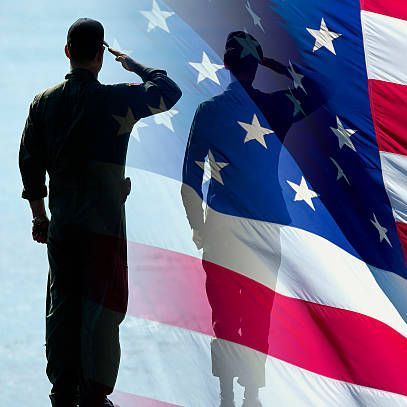 A soldier salutes in front of an american flag