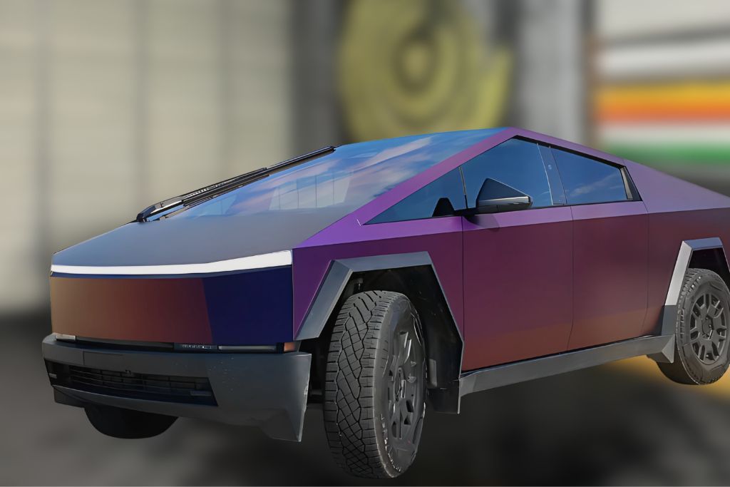 A Tesla Cybertruck featuring an iridescent color change wrap that transitions between purple and bronze hues depending on lighting. The dynamic finish accentuates the vehicle's angular design and futuristic appeal.