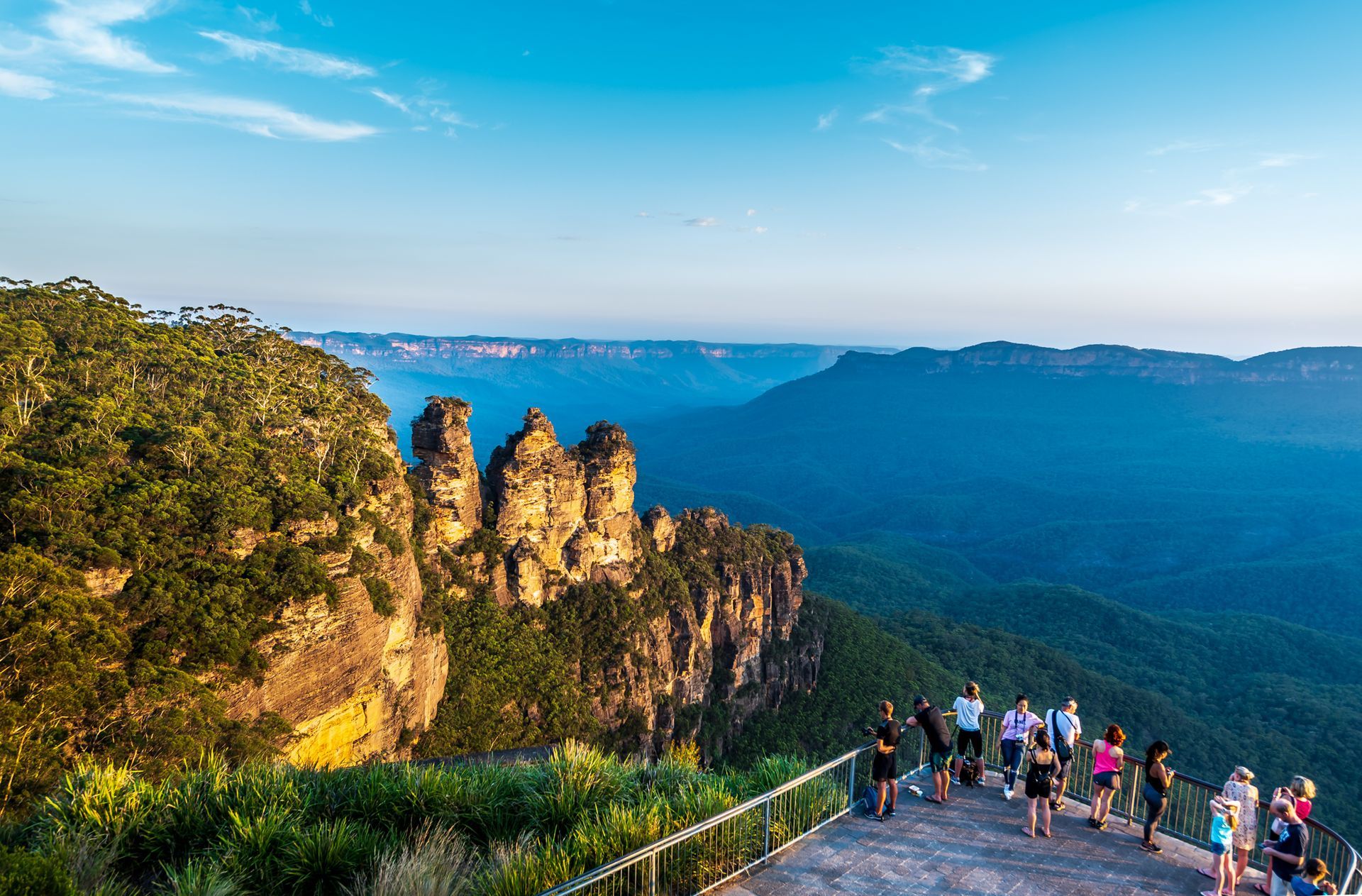 Three Sisters rock formation in the Blue Mountains, Australia. Tourists on a viewing platform.