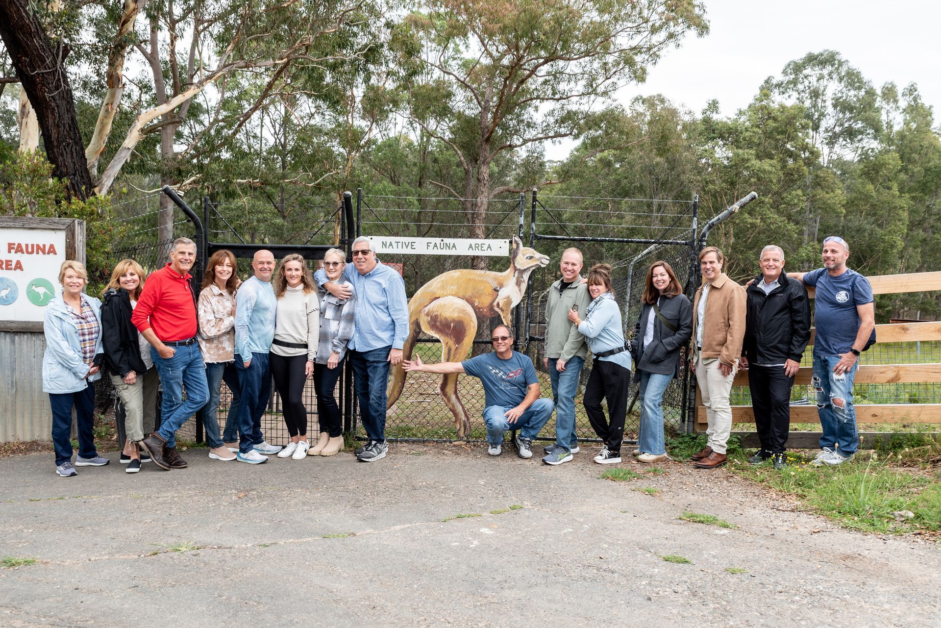 A group of people are posing for a picture in front of a camel