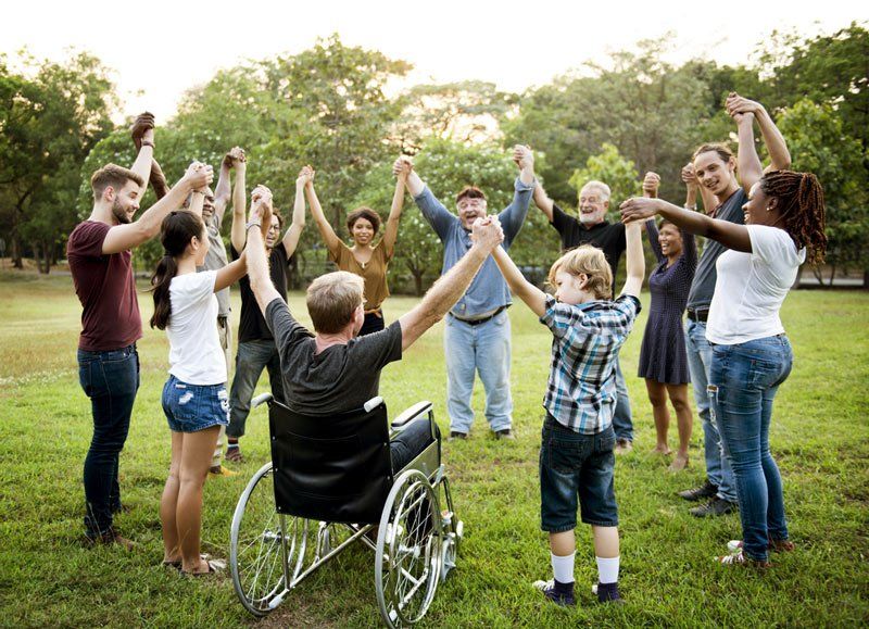 Group Of People Holding Hand Together In The Park — iCan Support Services Kawana QLD