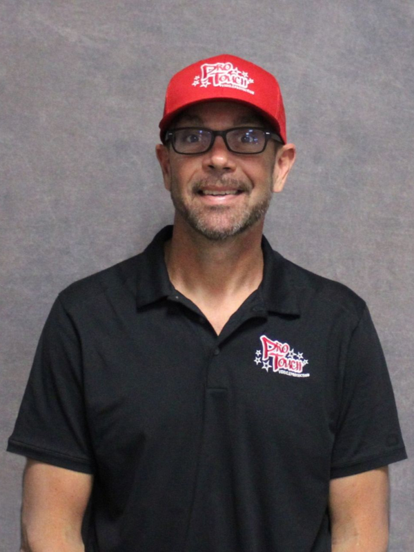 Man wearing a red hat and glasses, smiling, with a Pro Touch shirt.