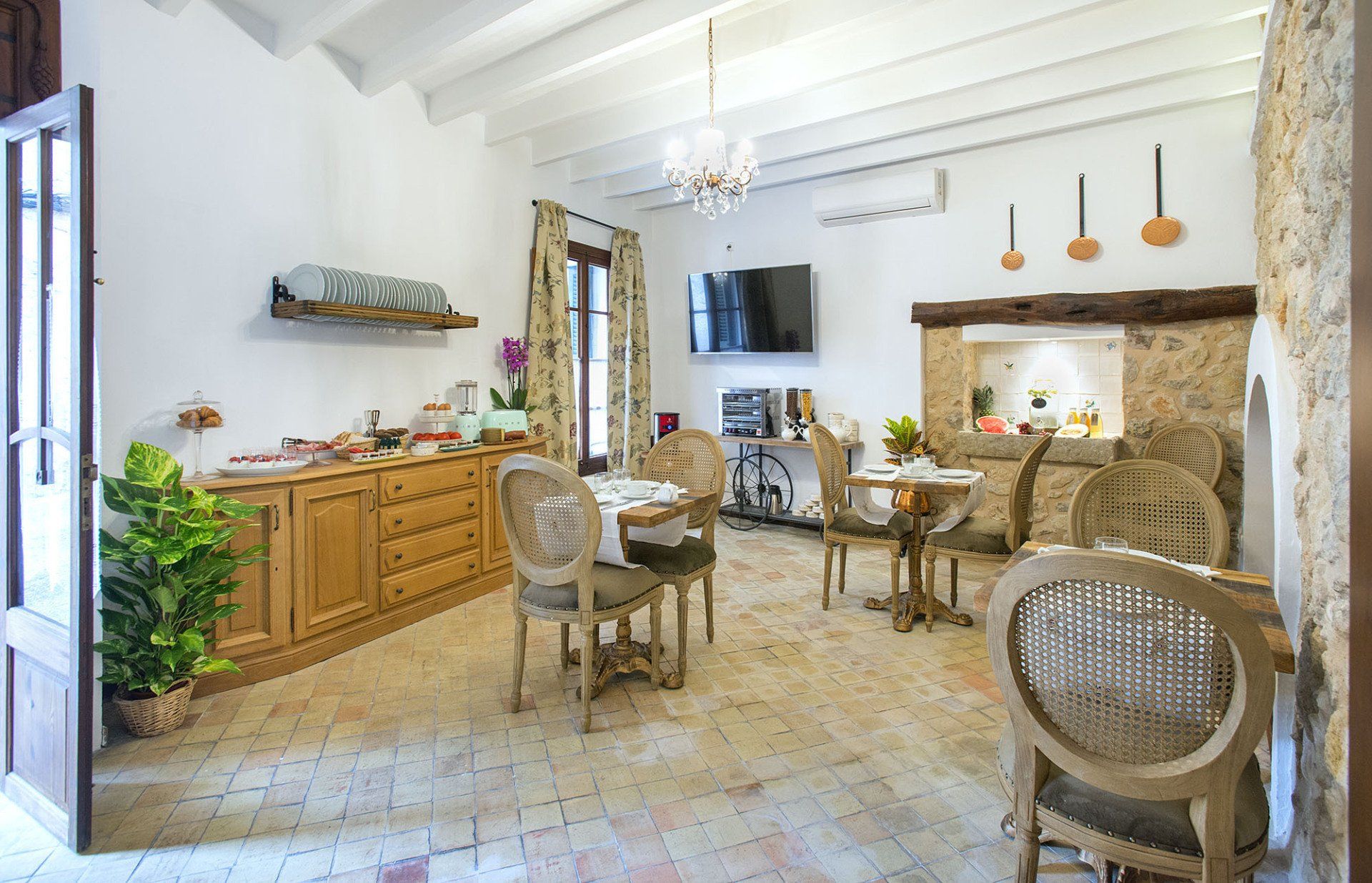 Breakfast room with wooden furniture, stone walls, and tables set for meals.
