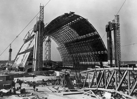 A black and white photo of a building under construction