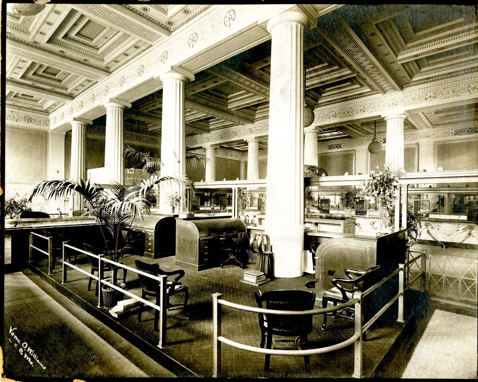 A black and white photo of a restaurant with tables and chairs