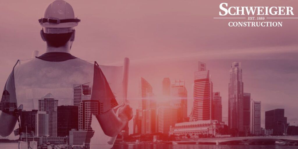 A construction worker is looking at a city skyline.