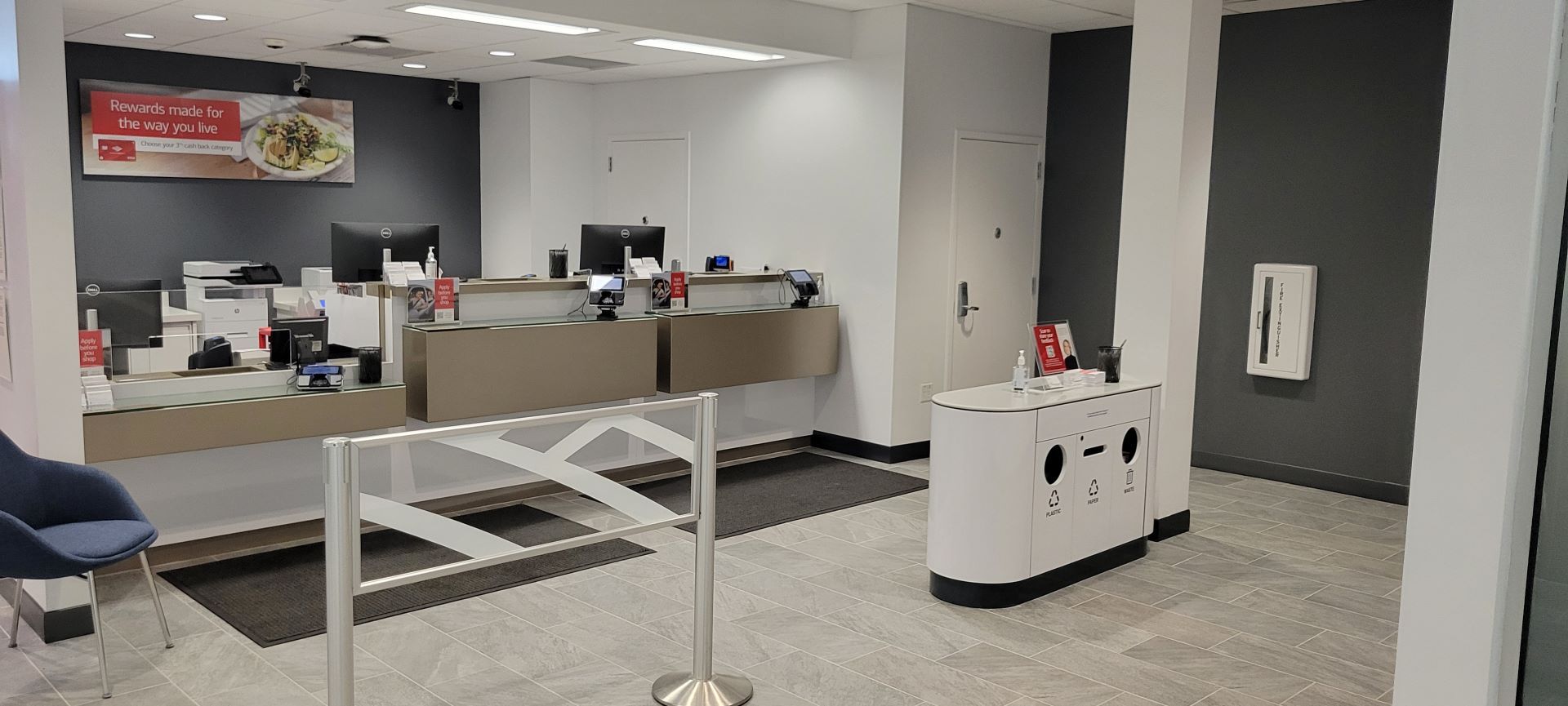 The inside of a bank with a counter and a sign on the wall.