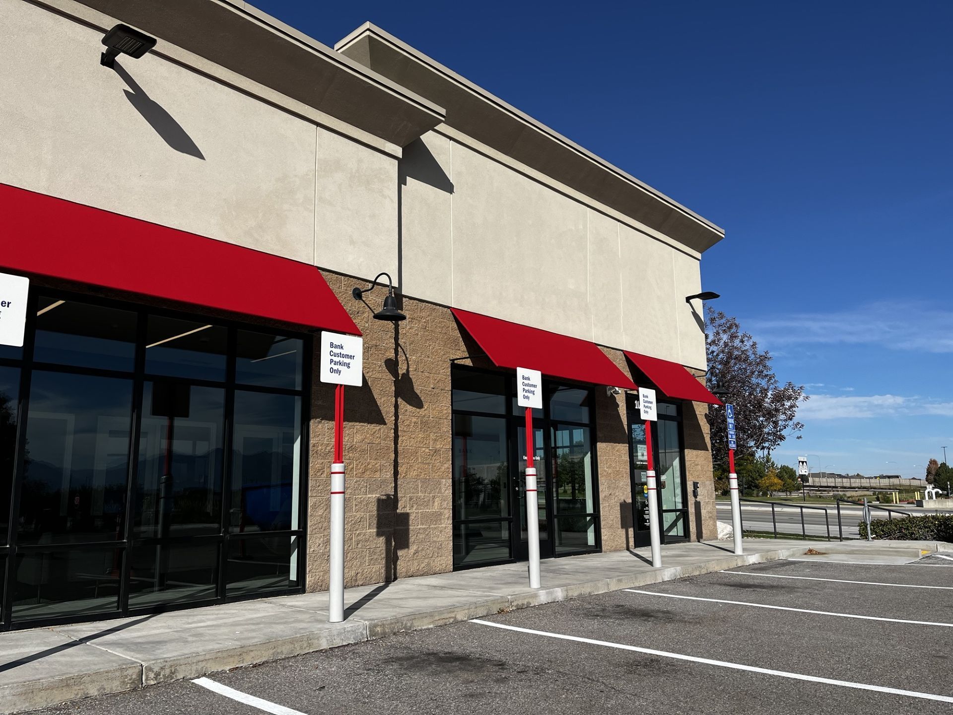 A bank of america building with a red awning