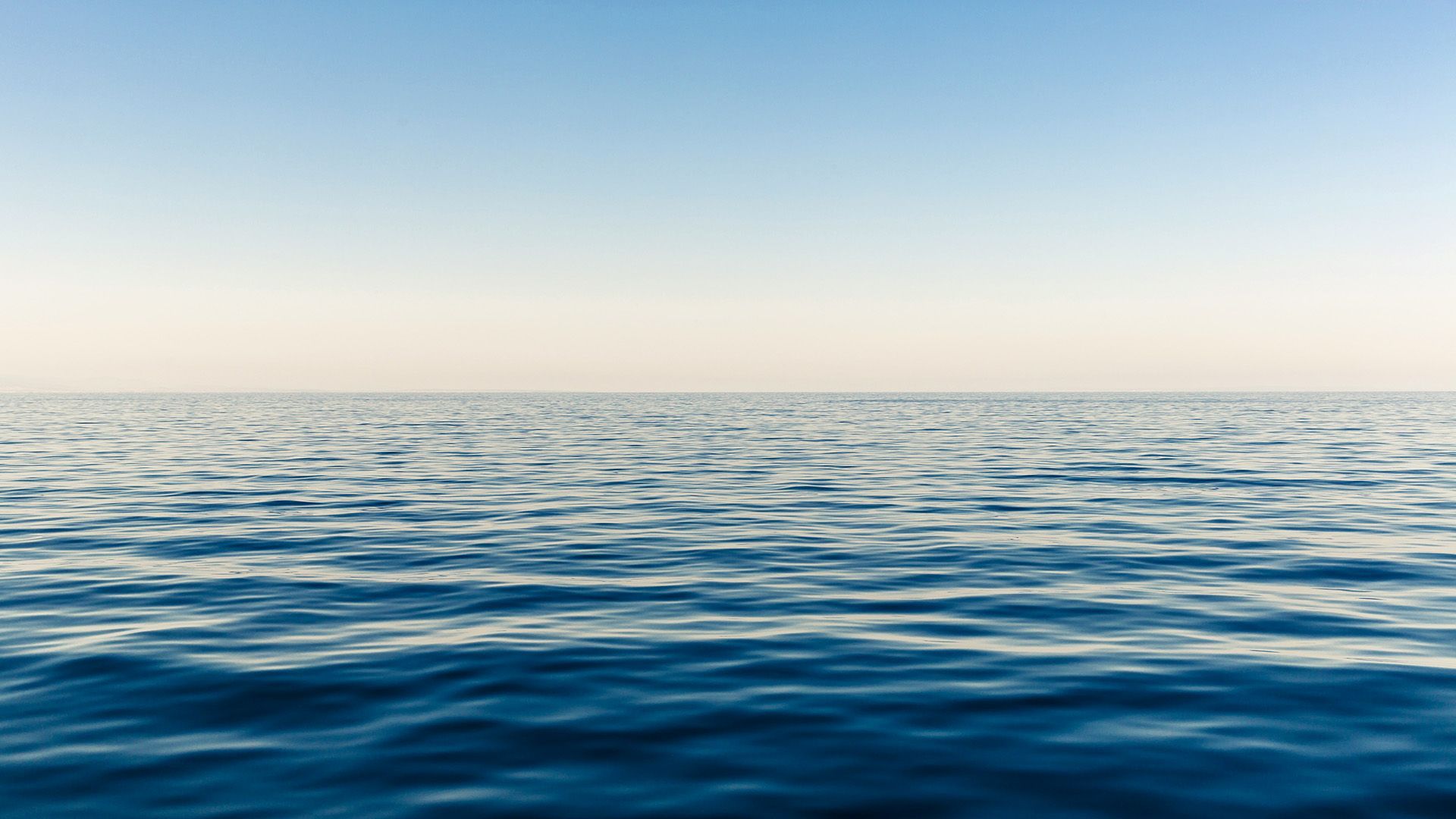 Blue ocean with clear sky on the horizon.