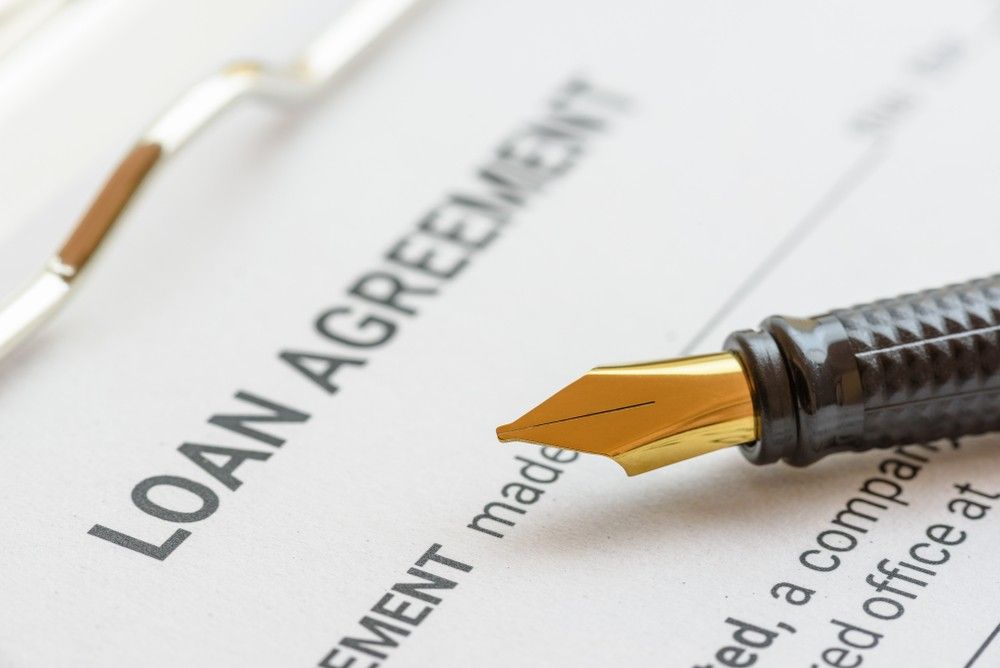 A Pen is Sitting on Top of a Loan Agreement — Loan Select Tablelands in Atherton, QLD