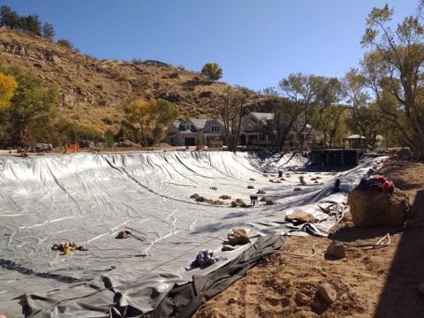 large liner secured by larger boulders
