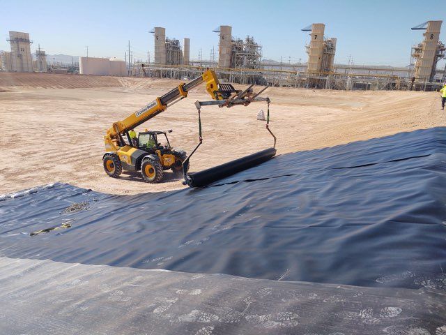 liner being rolled into place by large equipment