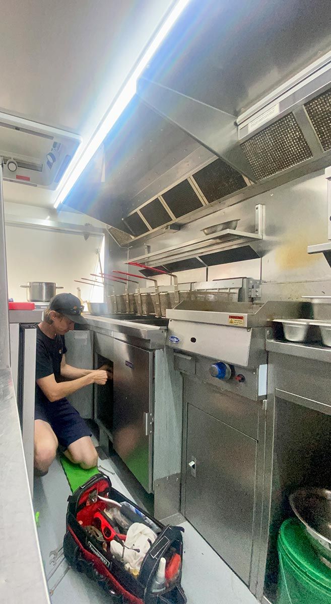 A Plumber Fixing An Industrial Kitchen — Lakesway Plumbing and Gas in Forster, NSW