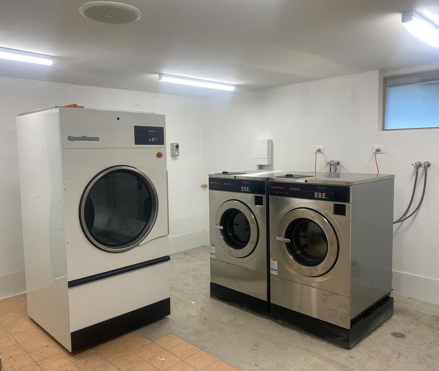A New Laundry Room WIth New Washing Machines And Driers — Lakesway Plumbing and Gas in Forster, NSW