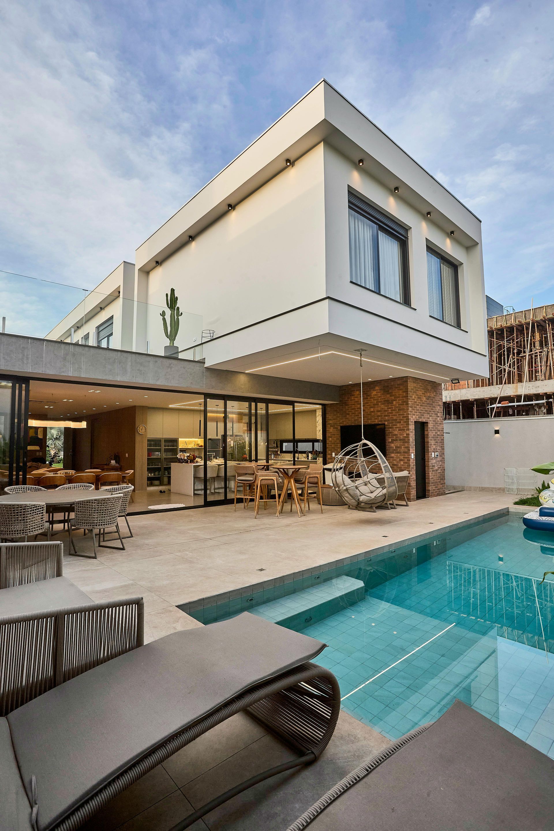 A large house with a swimming pool in front of it.