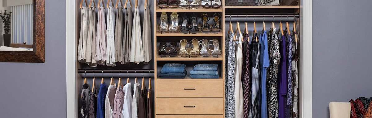 A closet filled with lots of clothes and shoes.