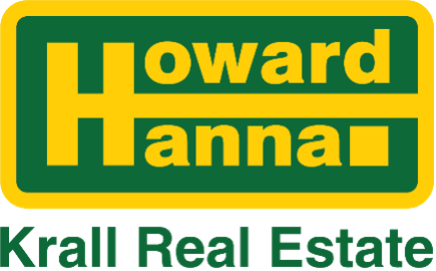 A green and yellow howard hanna krall real estate logo