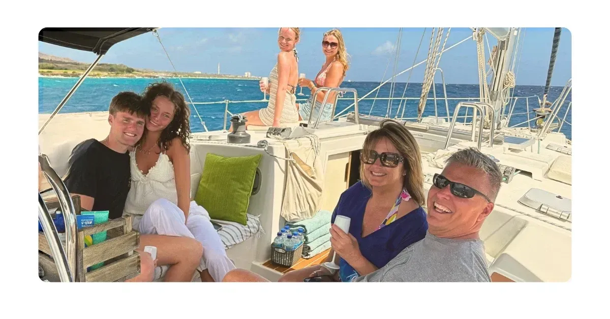 happy family with adult children together enjoying maxie sailing private experience