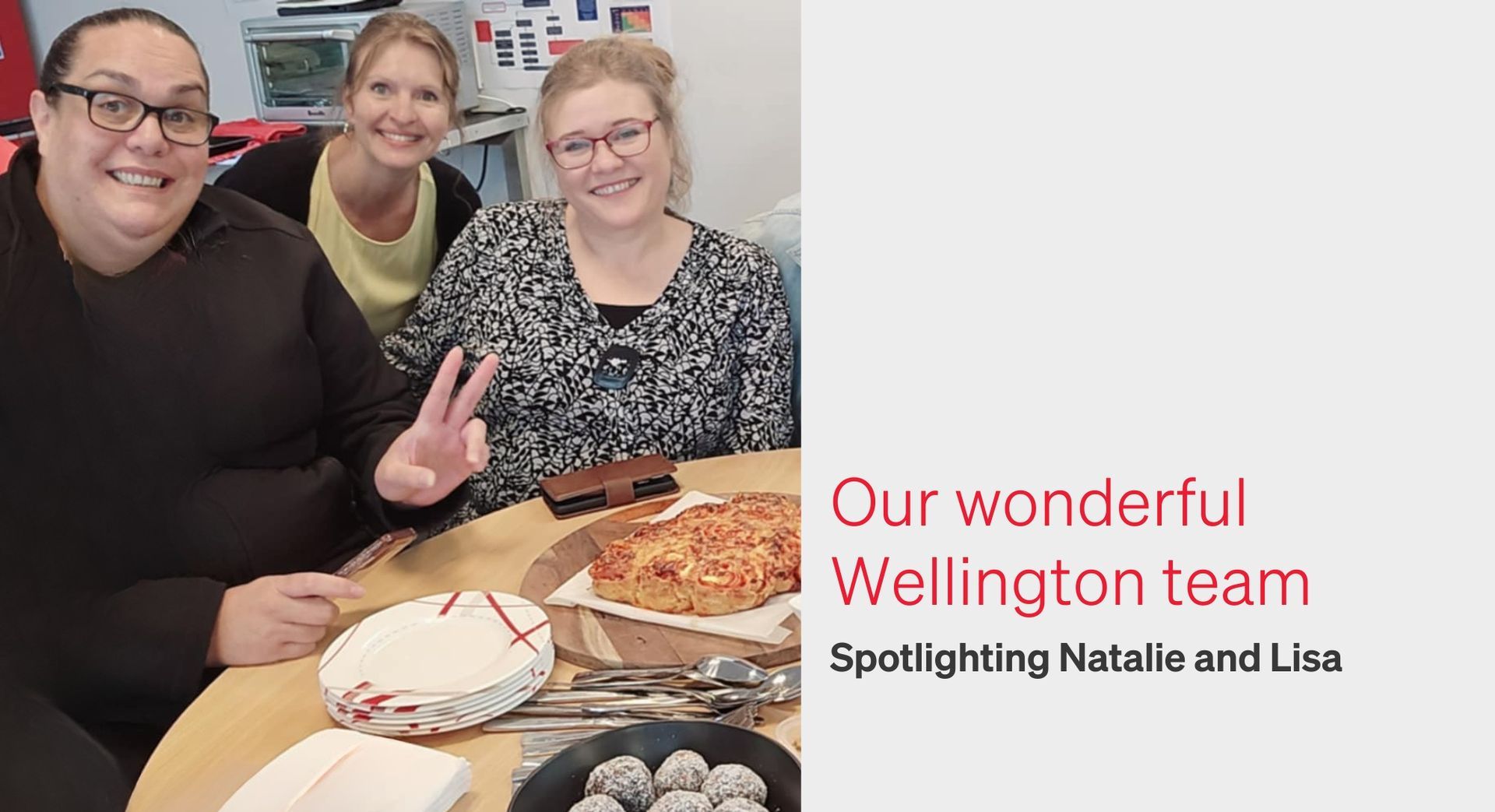 Three smiling people at a table; one is making a peace sign. Text says