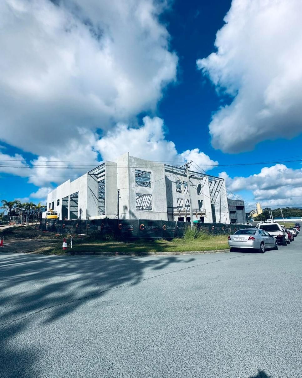 A Building is Under Construction With Cars Parked in Front of it — Construction Services in Gold Coast, QLD 