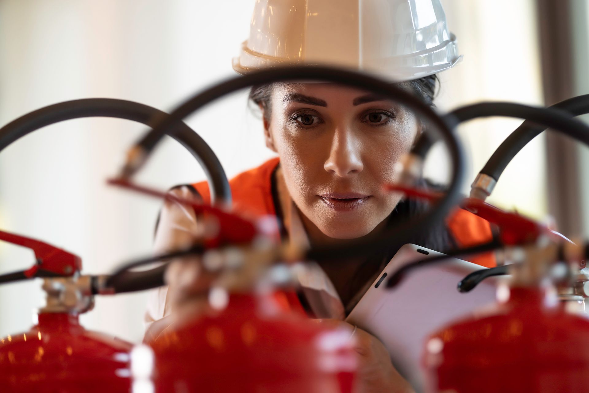 A professional safety inspector examines a fire extinguisher during a routine inspection.