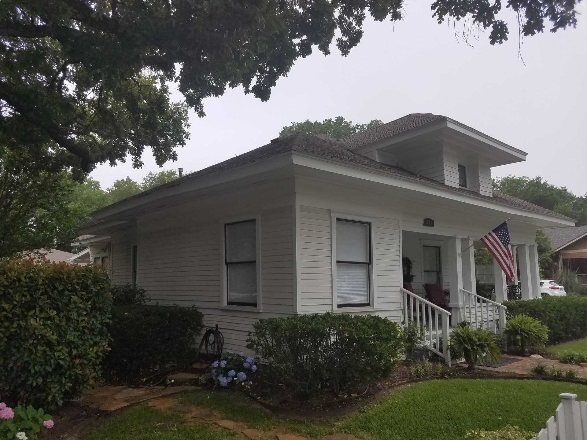 two men are working on the roof of a house