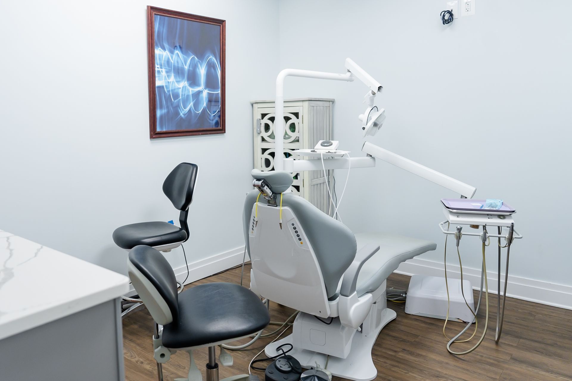 Exam room with a dental chair and X-ray artwork at Namu Dental Care, a family dentist in Stafford, VA