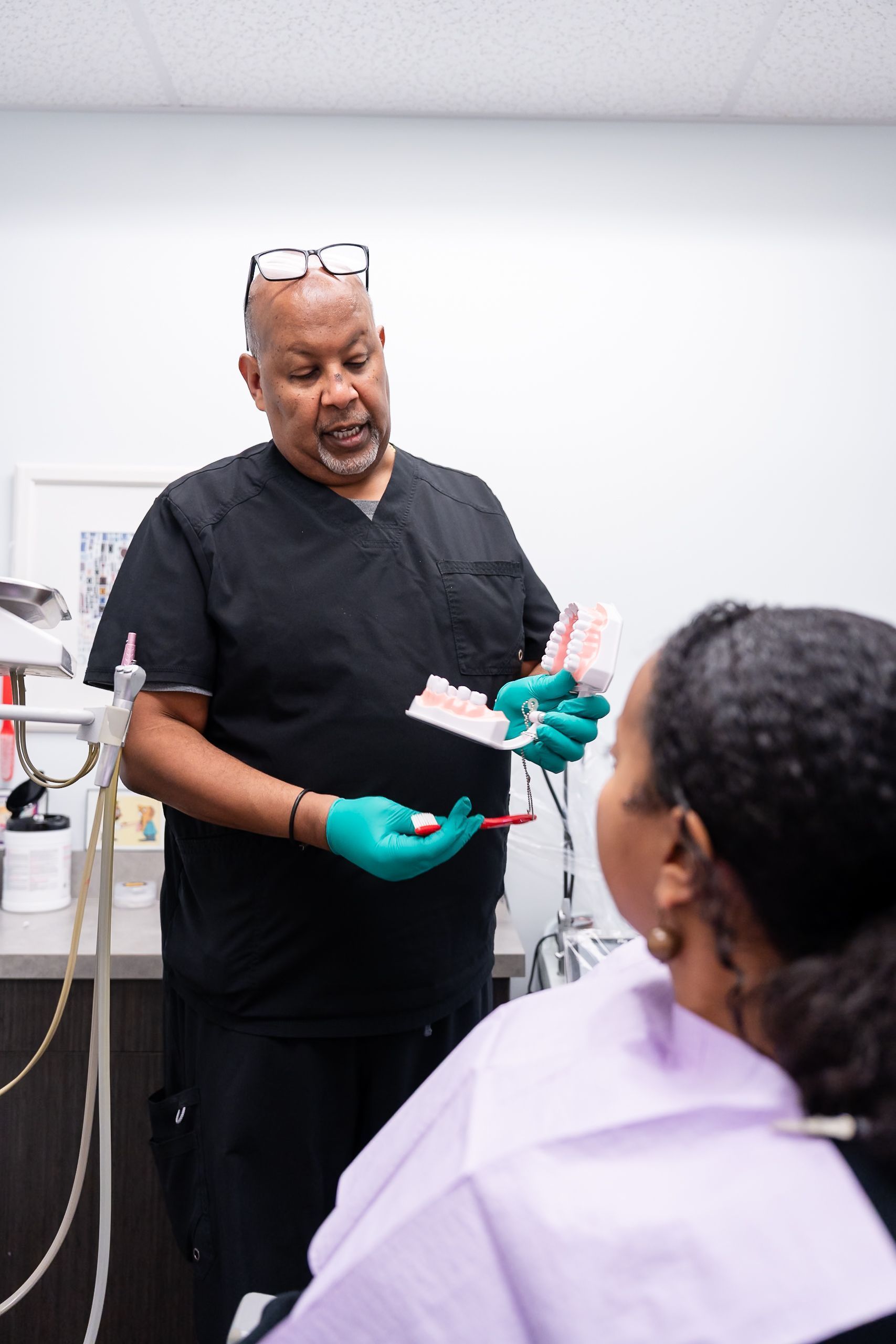 Dr. Daniel Dafo explaining options with a dental model at Namu Dental Care, a dental implant dentist in Stafford, VA