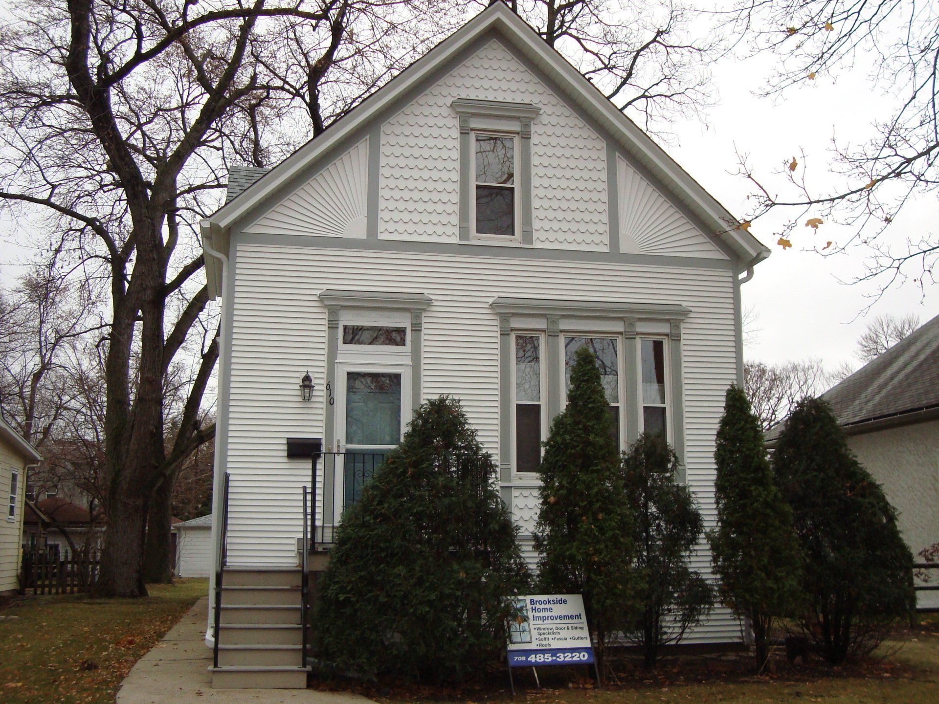 A white house with a for sale sign in front of it