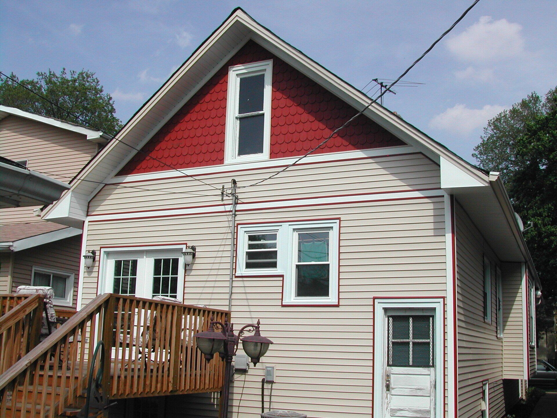 A house with a red roof and white trim