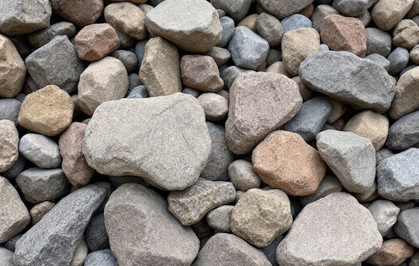 A pile of natural stone carved into rough brick shapes